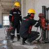 FastCore worker performing core drilling through a reinforced concrete wall in Dubai